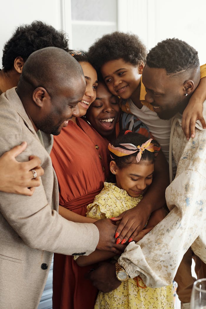 Services Heartwarming family group hug showcasing affection and togetherness indoors.
